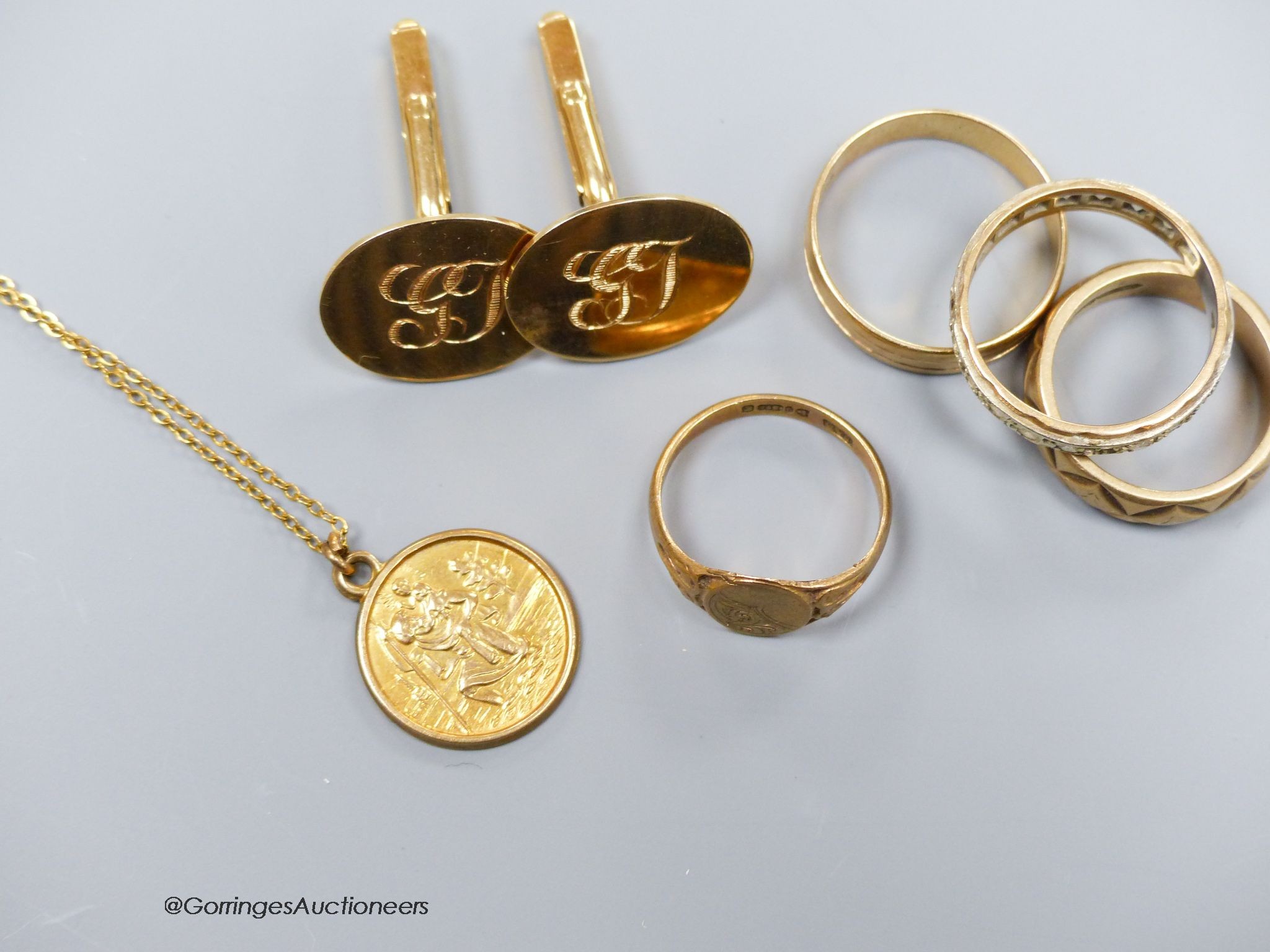 A pair of 9ct gold oval cufflinks with engraved initials, three various 9ct gold rings including paste set and a 9ct gold St Christopher pendant on gilt chain, gross 22.6g. total approx 20g